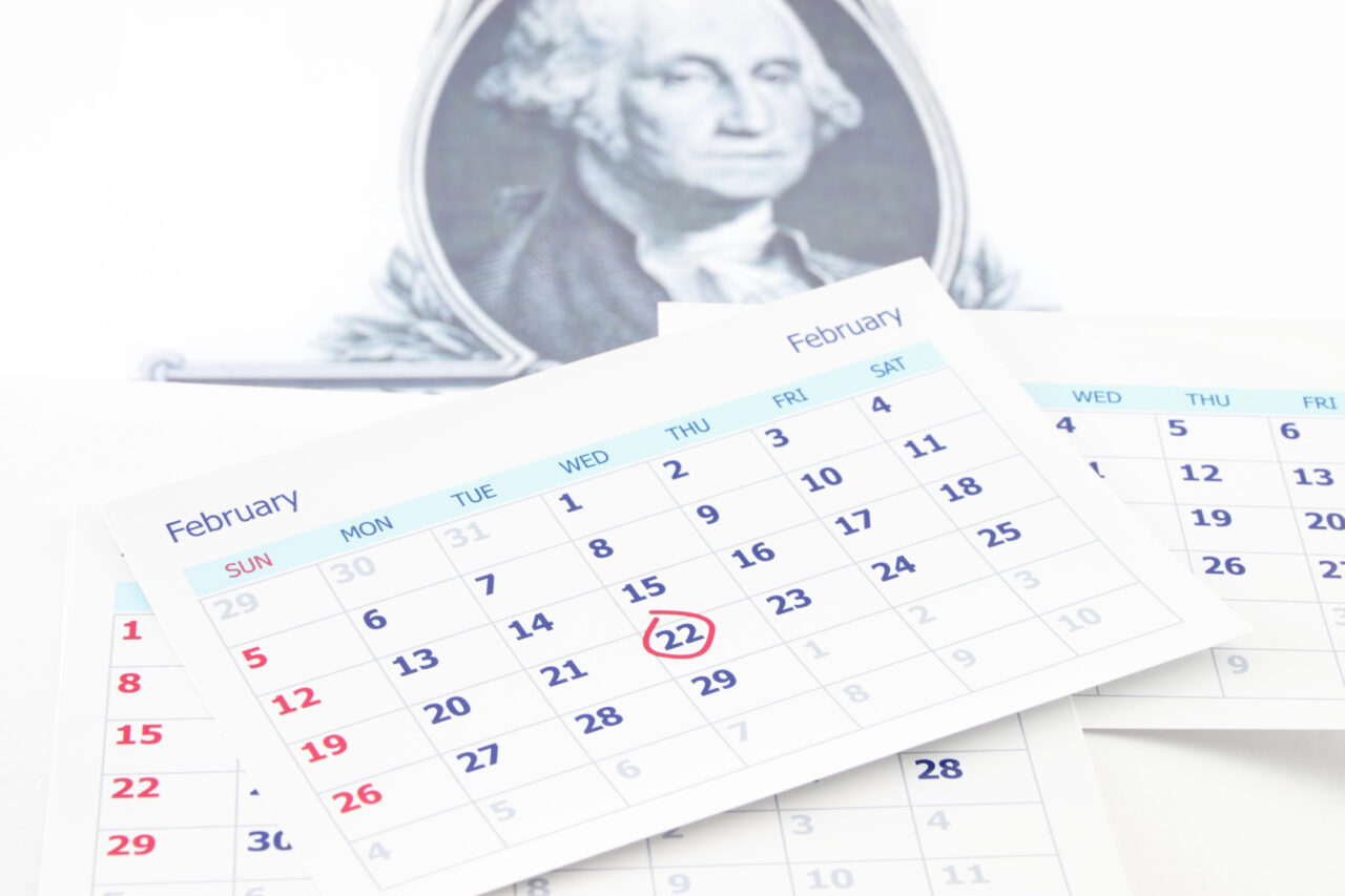 February calendar page with 22nd circles and image of George Washington in background.