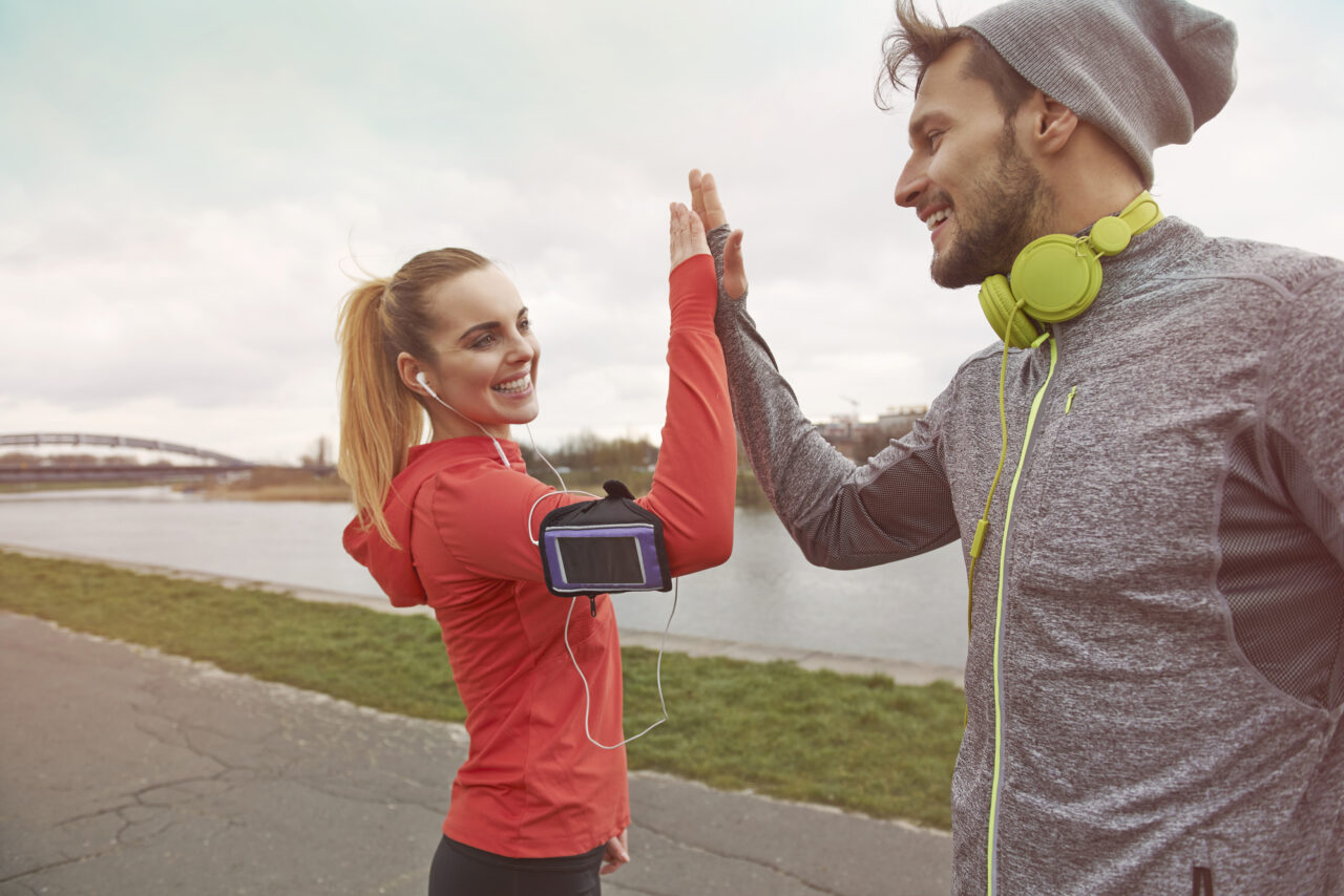 Happy workout partners give eachother high five.