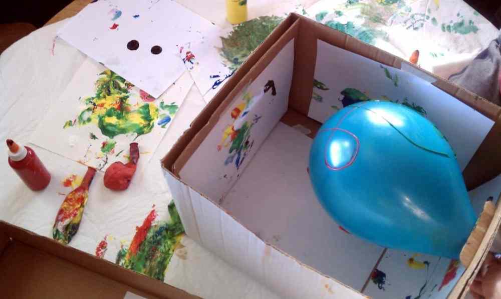 A Balloon in a box with paint around it